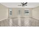 Spacious living room with tile flooring, neutral paint, and bright windows that fill the room with light at 23917 Pow Wow Dr, Lutz, FL 33559