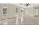 Living room featuring neutral paint and tile flooring, bathed in natural light from the large windows at 23917 Pow Wow Dr, Lutz, FL 33559