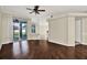 View of an open-concept living room with hardwood floors and sliding door access at 23917 Pow Wow Dr, Lutz, FL 33559