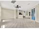 Open-concept living room boasts tile flooring and neutral paint, with easy access to the kitchen and backyard at 23917 Pow Wow Dr, Lutz, FL 33559