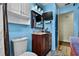 Cozy bathroom featuring a wood vanity, wall-mounted TV, and ample storage space at 2501 18Th S Ave, St Petersburg, FL 33712