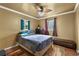 Cozy bedroom with hardwood floors, ceiling fan, and natural light from two windows at 2501 18Th S Ave, St Petersburg, FL 33712