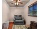 Cozy bedroom with hardwood floors, a ceiling fan, and a comfortable seating area at 2501 18Th S Ave, St Petersburg, FL 33712