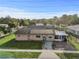 Street view of a single-story home featuring solar panels, screened porch, lawn and mature trees at 2501 18Th S Ave, St Petersburg, FL 33712