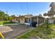 Exterior view of a single-story home and screen porch with a paved driveway and partial fencing at 2501 18Th S Ave, St Petersburg, FL 33712