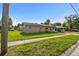 Street-level view of a cozy single-story home with lawn, partial fencing and street side parking at 2501 18Th S Ave, St Petersburg, FL 33712