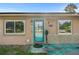 Up close view of the home's front door, with adjacent windows and exterior stone features at 2501 18Th S Ave, St Petersburg, FL 33712