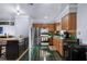 Charming kitchen featuring wood cabinets, stainless refrigerator, and green tile floors at 2501 18Th S Ave, St Petersburg, FL 33712