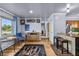 Spacious living room with wood floors, a colorful rug, and an adjacent kitchen at 2501 18Th S Ave, St Petersburg, FL 33712