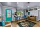 Bright living room featuring a stylish turquoise front door, and refinished hardwood floors at 2501 18Th S Ave, St Petersburg, FL 33712