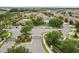 Aerial view showcasing a gated community entrance, pool area, clubhouse, and landscaped surroundings at 2628 Oleander Lakes Dr, Brandon, FL 33511