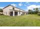 Expansive backyard view featuring a well-manicured lawn and screened-in patio for outdoor enjoyment at 2628 Oleander Lakes Dr, Brandon, FL 33511
