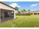 A view of the lawn and a covered patio at 2628 Oleander Lakes Dr, Brandon, FL 33511
