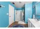 Bright blue bathroom featuring a white shower, vanity and blue accent rug at 2628 Oleander Lakes Dr, Brandon, FL 33511