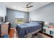 Bedroom features a window, hardwood floors, ceiling fan and side tables at 2628 Oleander Lakes Dr, Brandon, FL 33511