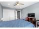 Bedroom features a ceiling fan, hardwood floors, a closet and a mounted television at 2628 Oleander Lakes Dr, Brandon, FL 33511