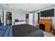 Bedroom features a bed with black comforter, a desk, and access to a walk-in closet and bathroom at 2628 Oleander Lakes Dr, Brandon, FL 33511