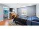 Bedroom featuring a desk, television and ensuite bathroom at 2628 Oleander Lakes Dr, Brandon, FL 33511