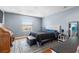 Bedroom features hardwood floors, a window and a bed with tufted headboard at 2628 Oleander Lakes Dr, Brandon, FL 33511