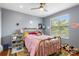 Bedroom with hardwood floors, a ceiling fan, and a metal bed frame at 2628 Oleander Lakes Dr, Brandon, FL 33511