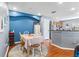 Dining room featuring blue accent wall, round rug, and modern decor at 2628 Oleander Lakes Dr, Brandon, FL 33511