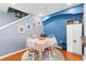 Dining room showcasing blue accent wall, round rug, and stairway at 2628 Oleander Lakes Dr, Brandon, FL 33511