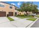 Charming townhome featuring a two-car garage, landscaping, and visitor parking at 2628 Oleander Lakes Dr, Brandon, FL 33511