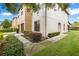 Exterior side view of the home featuring landscaping and a sidewalk at 2628 Oleander Lakes Dr, Brandon, FL 33511