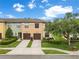 Inviting townhome featuring a two-car garage, manicured landscaping, and a charming, well-maintained exterior at 2628 Oleander Lakes Dr, Brandon, FL 33511