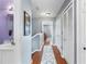 Hallway features hardwood floors, a laundry chute, and access to bedrooms and bathrooms at 2628 Oleander Lakes Dr, Brandon, FL 33511