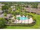 Aerial view of a community pool surrounded by palm trees and landscaping at 2628 Oleander Lakes Dr, Brandon, FL 33511