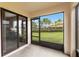 View from screened in porch featuring a serene outdoor space and sliding glass doors to the yard at 2628 Oleander Lakes Dr, Brandon, FL 33511