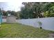 Backyard featuring green grass, a storage shed, and a privacy fence at 2715 Bel Aire Cir, Tampa, FL 33614