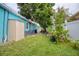Backyard featuring an AC unit, seating area, green grass, and tropical plants at 2715 Bel Aire Cir, Tampa, FL 33614
