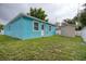 Backyard featuring a storage shed, green grass, and a privacy fence at 2715 Bel Aire Cir, Tampa, FL 33614