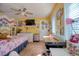 Bright bedroom with wood-look tile flooring, ceiling fan, and large windows at 2715 Bel Aire Cir, Tampa, FL 33614