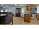 Dining room with wood-look tile flooring, and a view to the living room at 2715 Bel Aire Cir, Tampa, FL 33614