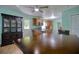 Dining room with wood-look tile flooring, and a view to the kitchen at 2715 Bel Aire Cir, Tampa, FL 33614