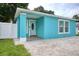 Covered front porch with turquoise walls, white trim, and a brick-paved entrance at 2715 Bel Aire Cir, Tampa, FL 33614