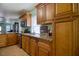 The kitchen has granite counters, stainless steel appliances, and wood-look tile flooring at 2715 Bel Aire Cir, Tampa, FL 33614