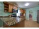 Kitchen boasts granite countertops, stainless steel appliances, and stylish cabinetry at 2715 Bel Aire Cir, Tampa, FL 33614