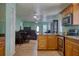 Open-concept kitchen and living room with matching flooring and paint color, ceiling fans throughout at 2715 Bel Aire Cir, Tampa, FL 33614