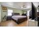 Bright main bedroom with wood-look tile flooring, ceiling fan, and large windows at 2715 Bel Aire Cir, Tampa, FL 33614