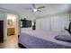 Bright main bedroom with wood-look tile flooring, ceiling fan, and view to closets at 2715 Bel Aire Cir, Tampa, FL 33614