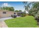 The backyard features a green lawn, patio with seating, and a screened-in lanai at 2861 Pinellas Point S Dr, St Petersburg, FL 33712