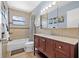 Bathroom with a brown vanity cabinet, white sink, tile flooring, and a shower over tub at 2861 Pinellas Point S Dr, St Petersburg, FL 33712