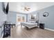 Bedroom with a double door to the pool area, light blue paint, and hardwood floors at 2861 Pinellas Point S Dr, St Petersburg, FL 33712