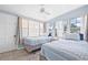Bedroom with two twin beds, two large windows and tile flooring at 2861 Pinellas Point S Dr, St Petersburg, FL 33712