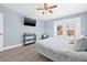 Bedroom features light blue paint, wood floors, and a view of the pool through the patio doors at 2861 Pinellas Point S Dr, St Petersburg, FL 33712