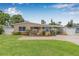 Charming home boasts a well-manicured lawn and a welcoming brick walkway, leading to a covered carport at 2861 Pinellas Point S Dr, St Petersburg, FL 33712